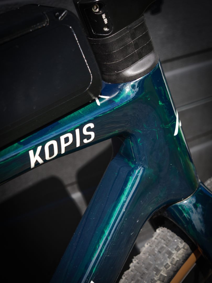 Close-up of the Kopis translucent emerald paintwork and frame logo