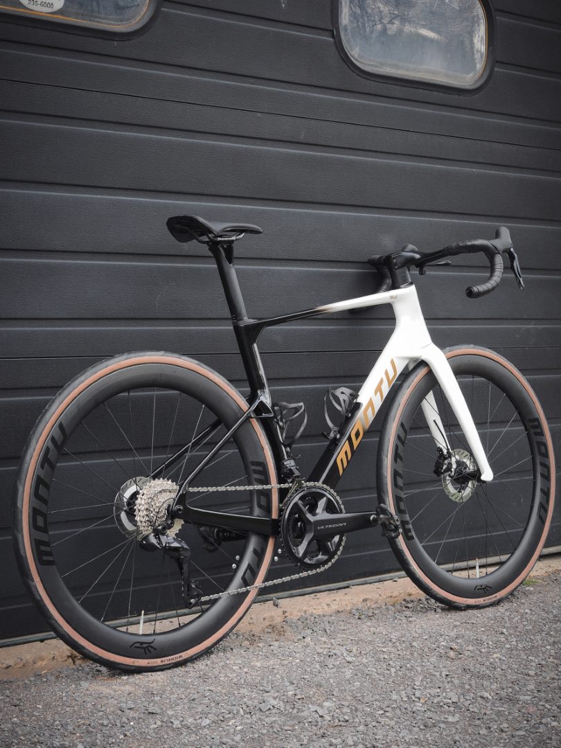 Montu Nui V2 three-quarter rear showing Ultegra Di2 drivetrain and deep wheels