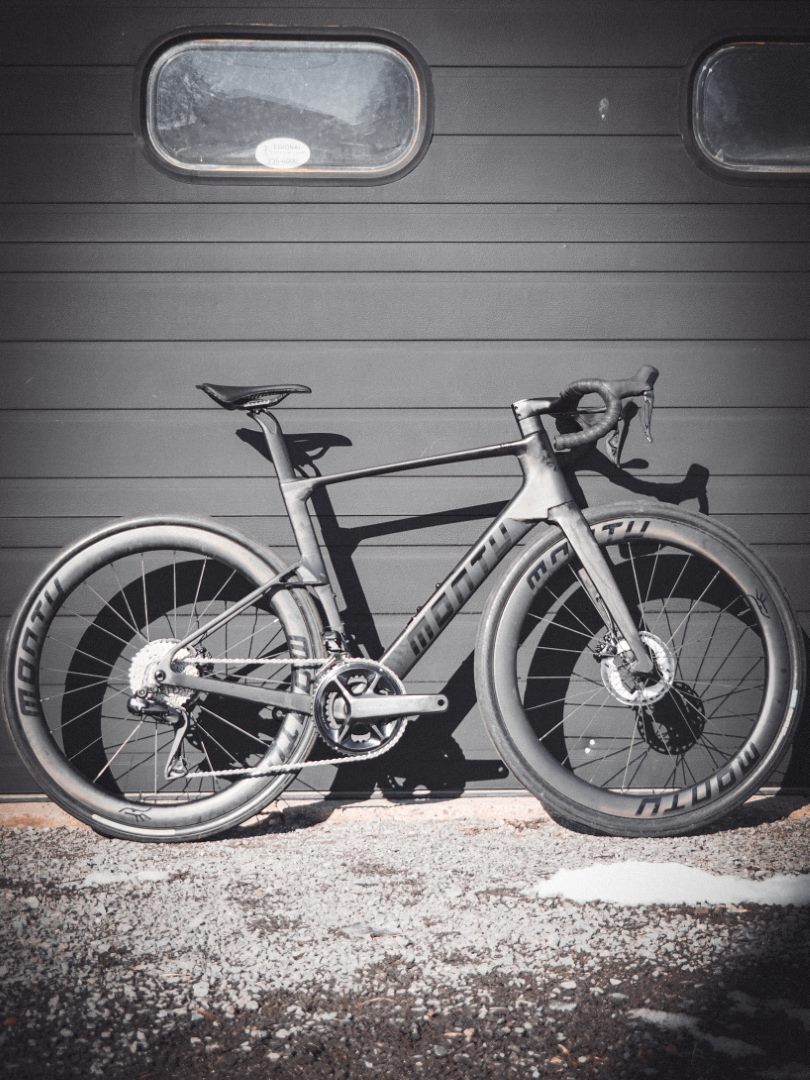 Montu Nui V2 naked carbon full side profile against dark wall