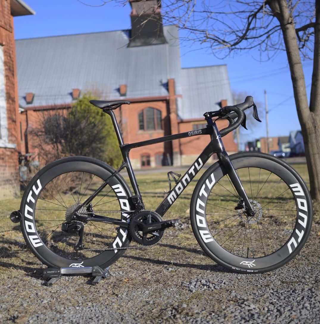 Montu Osiris road bike in naked carbon with silver accents on deep Montu carbon wheels